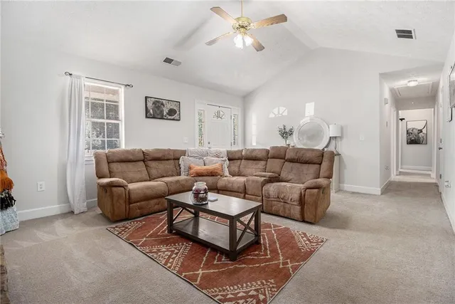 a living room with furniture a lamp and a window