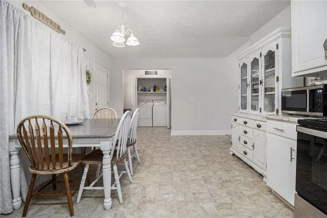 a view of a dining room with furniture and chandelier