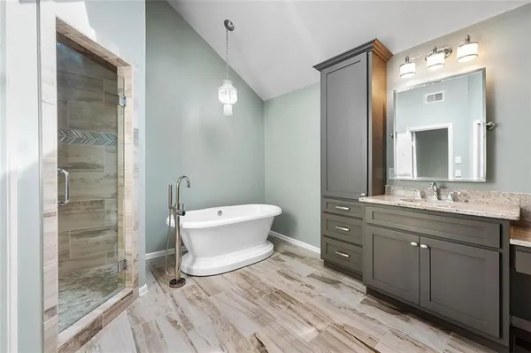 a bathroom with a double vanity sink mirror and toilet