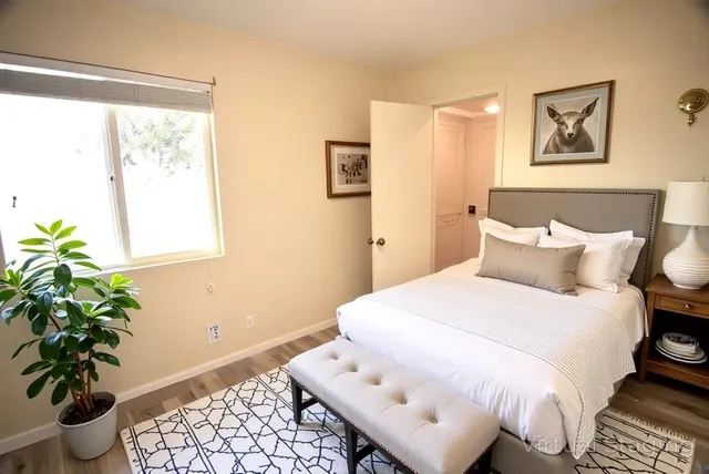 a bedroom with a bed and a potted plant