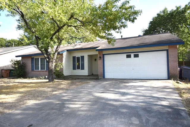 a house that has a tree in front of it
