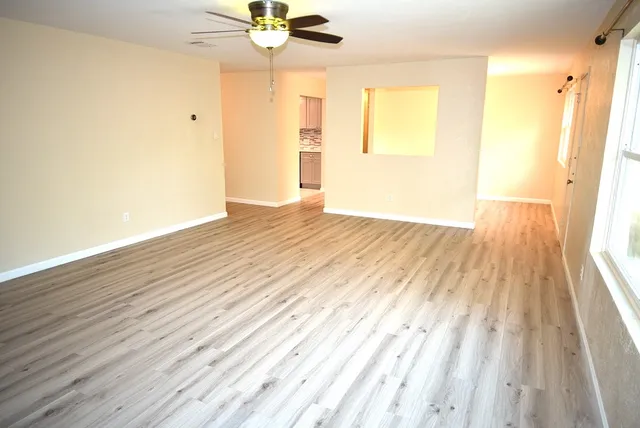 wooden floor in an empty room with a window