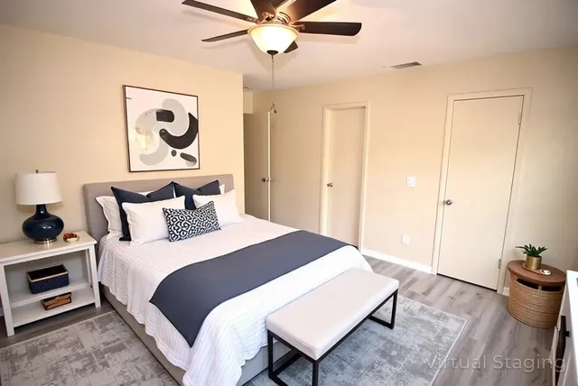 a bedroom with bed and wooden floor