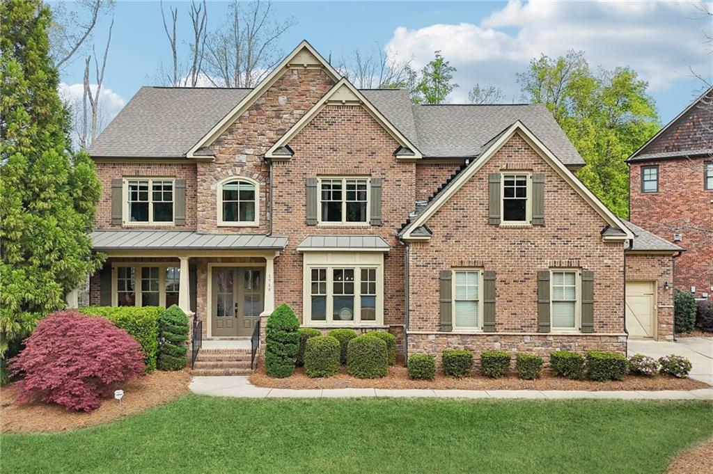 1710 Bramble Bush Way Suwanee, GA 30024 - Photo 1 of 40 front view of a house with a yard
