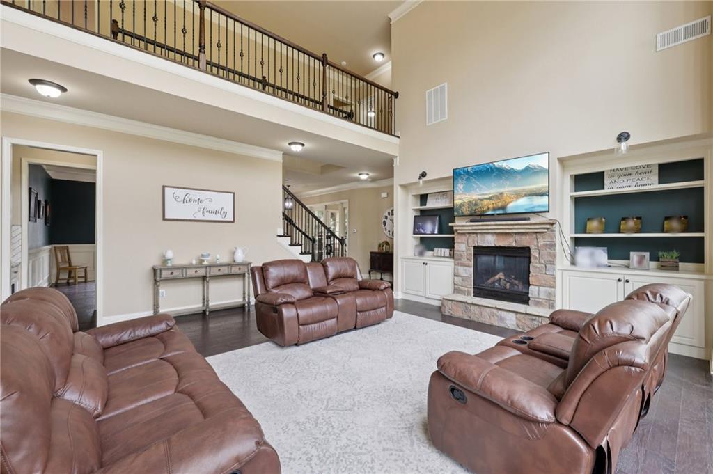 1710 Bramble Bush Way Suwanee, GA 30024 - Photo 11 of 40 a living room with furniture a fireplace and a flat screen tv
