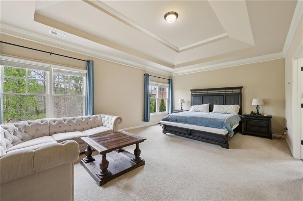1710 Bramble Bush Way Suwanee, GA 30024 - Photo 18 of 40 a bedroom with a bed and wooden floor