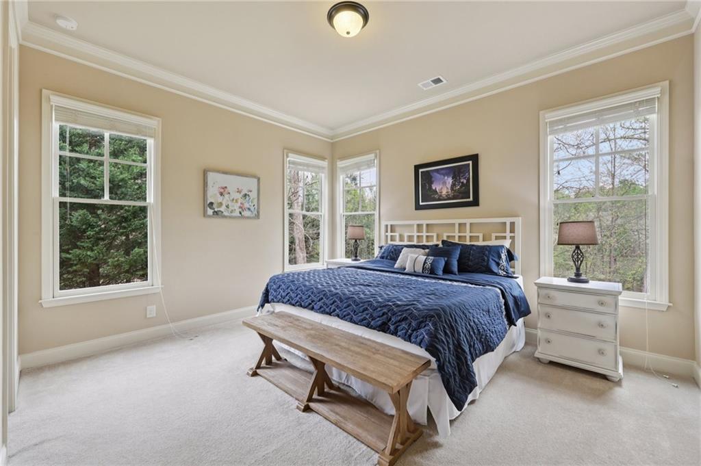 1710 Bramble Bush Way Suwanee, GA 30024 - Photo 22 of 40 a spacious bedroom with a bed and a window