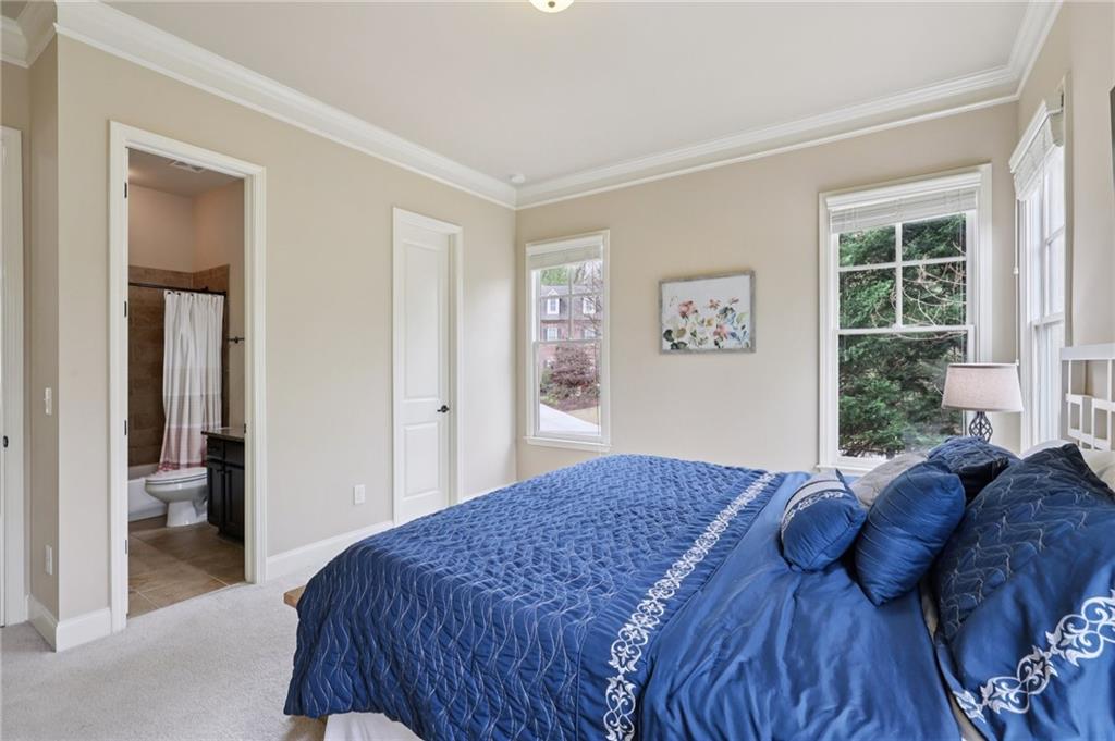 1710 Bramble Bush Way Suwanee, GA 30024 - Photo 23 of 40 a bedroom with a large bed and a window
