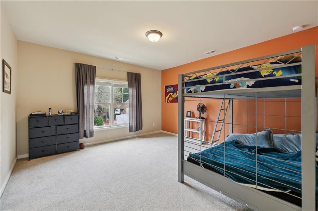 1710 Bramble Bush Way Suwanee, GA 30024 - Photo 24 of 40 a bedroom with furniture and a window