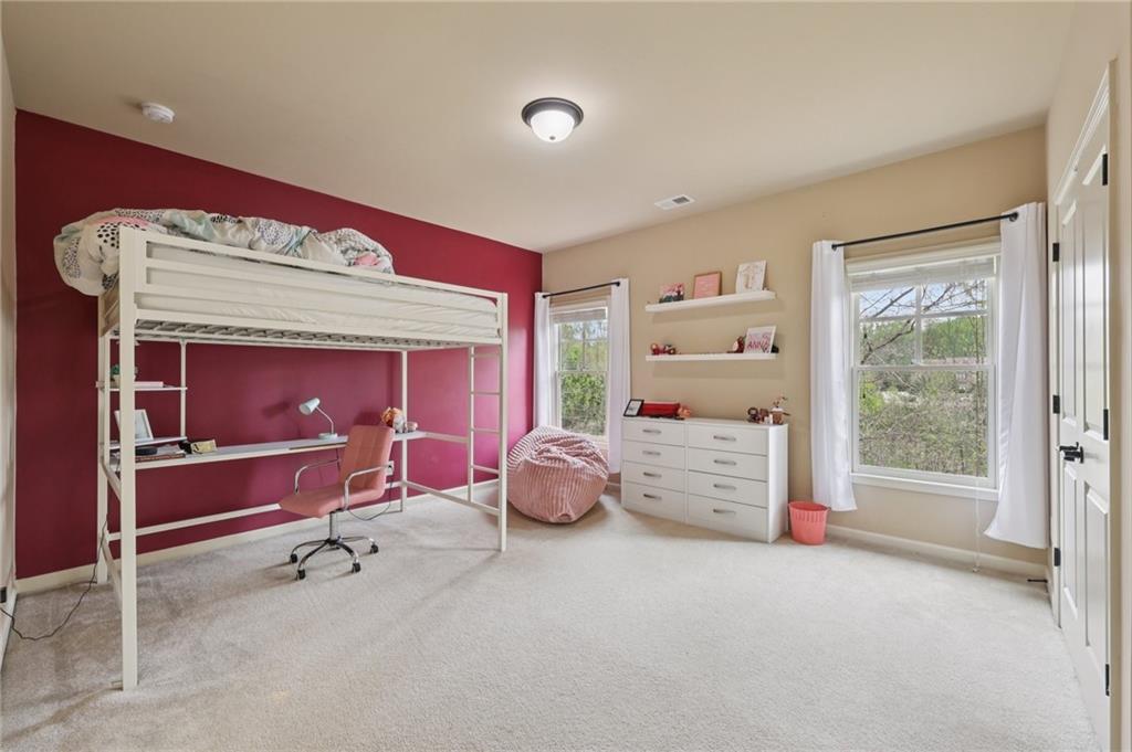 1710 Bramble Bush Way Suwanee, GA 30024 - Photo 26 of 40 a bedroom with furniture and a window