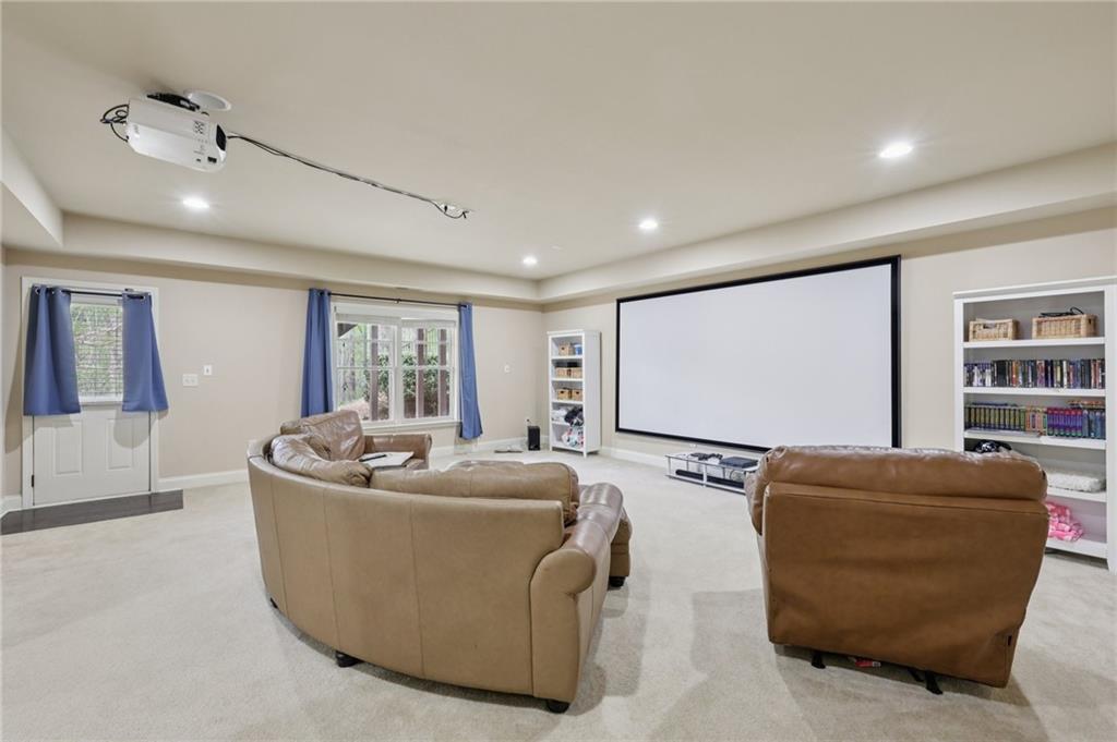 1710 Bramble Bush Way Suwanee, GA 30024 - Photo 29 of 40 a living room with furniture projector and screen
