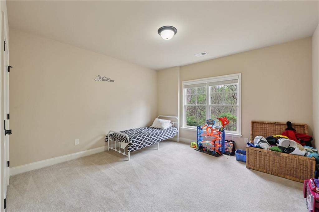 1710 Bramble Bush Way Suwanee, GA 30024 - Photo 31 of 40 a bedroom with furniture and a window