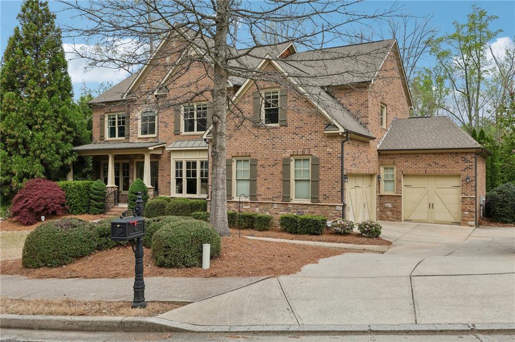 1710 Bramble Bush Way Suwanee, GA 30024 - Photo 5 of 40 a front view of a house with a yard and trees