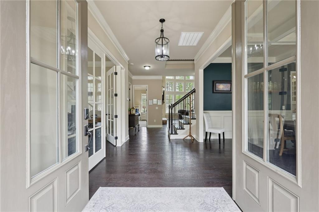1710 Bramble Bush Way Suwanee, GA 30024 - Photo 6 of 40 an entryway space and a livingroom with furniture wooden floor a chandelier