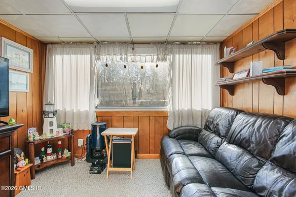 a living room with furniture a fireplace and a chandelier