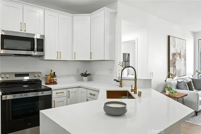 a kitchen with a sink a stove and cabinets