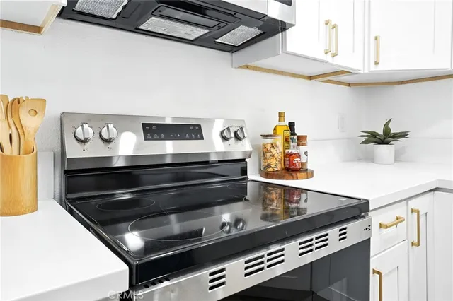 a stove top oven sitting inside of a kitchen