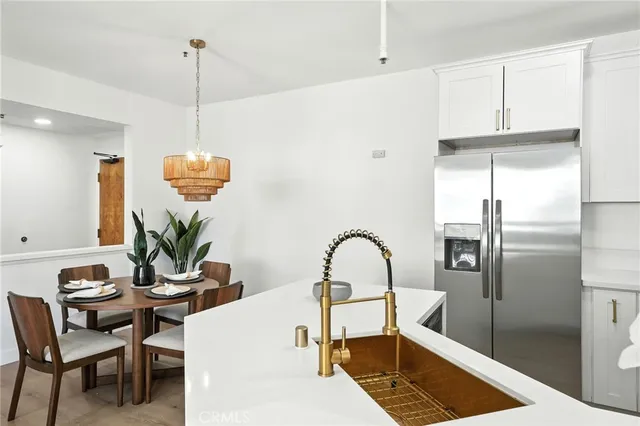 a living room with furniture a window and kitchen view