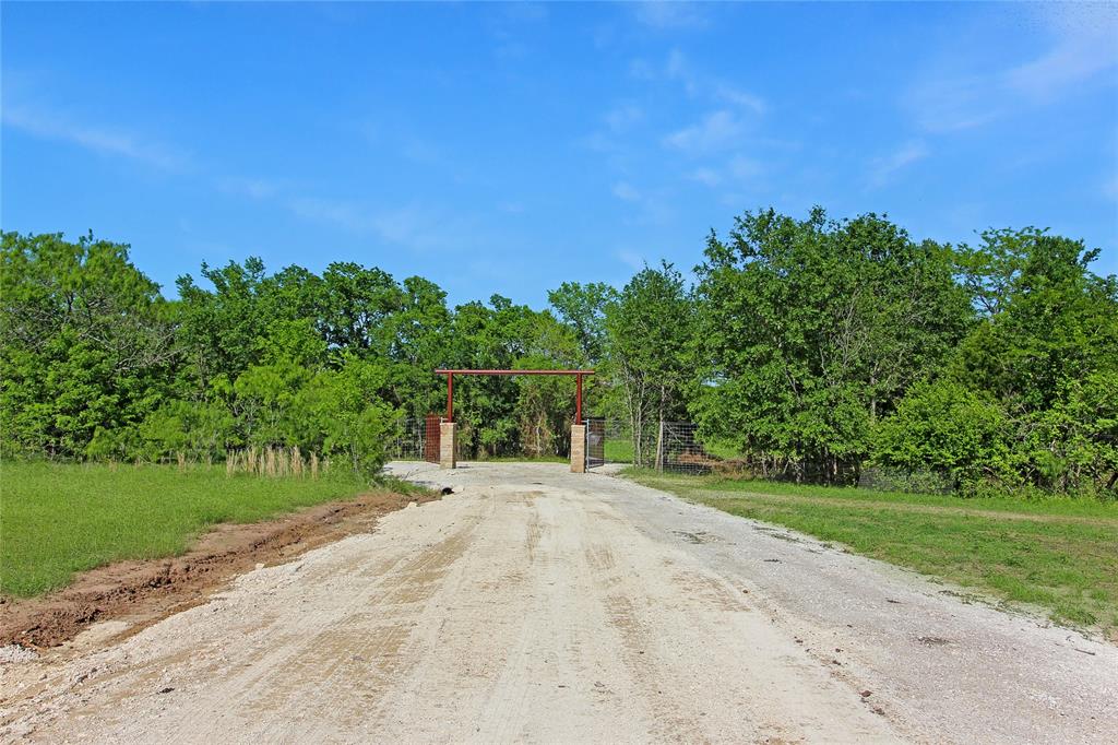 7304 Shady Lane Scurry, TX 75158 - Photo 3 of 40 View of road with a gated entry and a gate