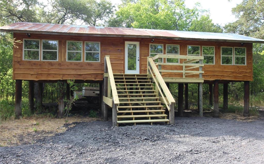 7304 Shady Lane Scurry, TX 75158 - Photo 35 of 40 Chalet / cabin featuring a carport, a wooden deck, a metal roof, and stairs