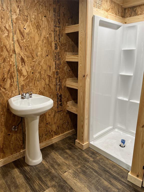 7304 Shady Lane Scurry, TX 75158 - Photo 36 of 40 Bathroom with dark wood finished floors and a stall shower