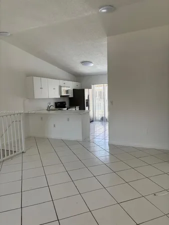 a kitchen with stainless steel appliances a refrigerator sink and cabinets
