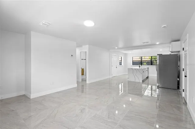a view of kitchen with furniture and refrigerator
