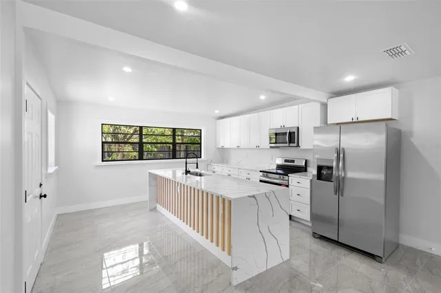 a kitchen with refrigerator and window