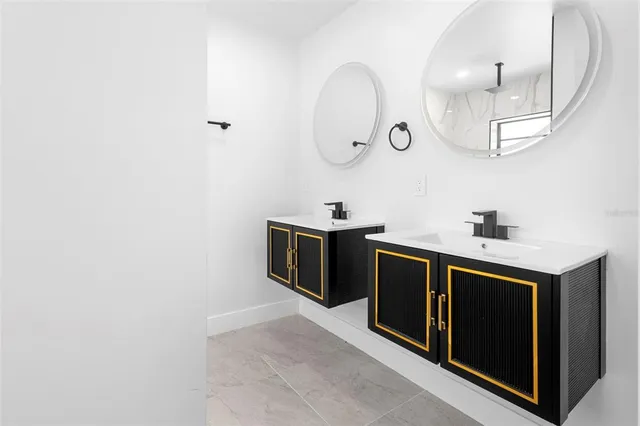 a kitchen with stainless steel appliances granite countertop a sink and a stove with wooden floor