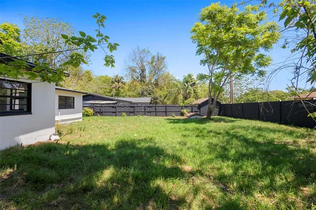 a backyard of a house with lots of green space