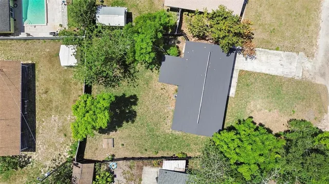 an aerial view of a house with a yard and potted plants