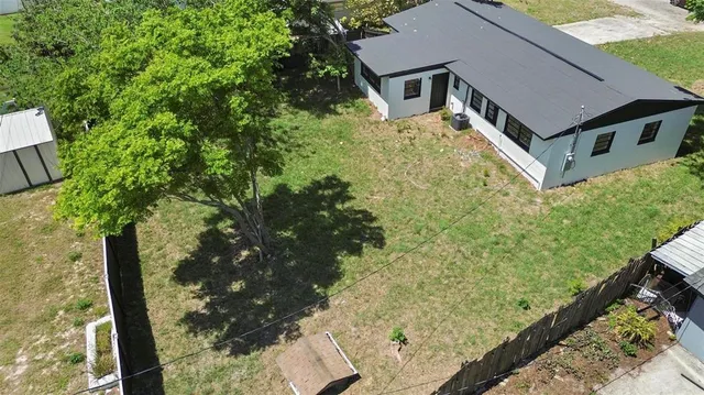 a aerial view of a house with large trees
