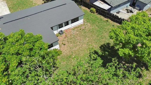 an aerial view of a house with pool