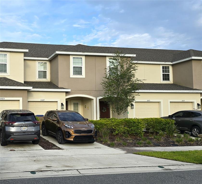 3609 Anibal Street Kissimmee, FL 34746 - Photo 1 of 17 a couple of cars parked in front of a house
