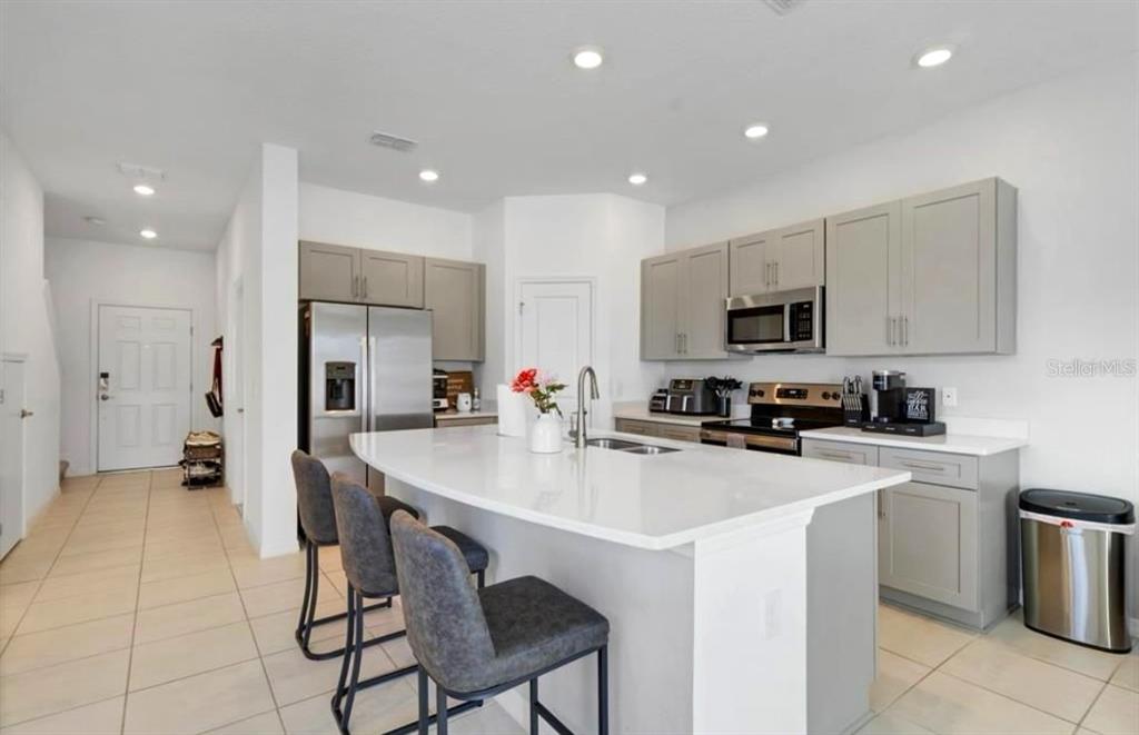 3609 Anibal Street Kissimmee, FL 34746 - Photo 12 of 17 a kitchen with appliances a sink cabinets and a counter top space