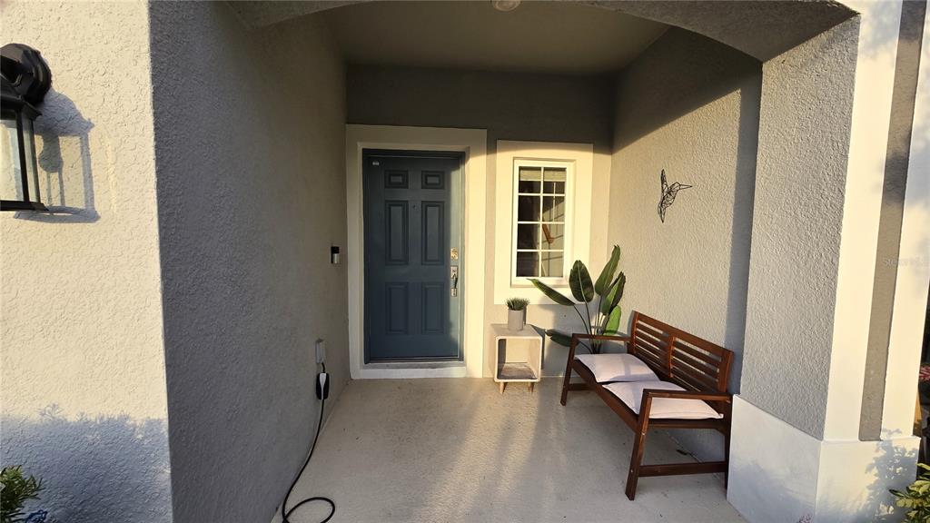 3609 Anibal Street Kissimmee, FL 34746 - Photo 4 of 17 a balcony with chairs and a potted plant