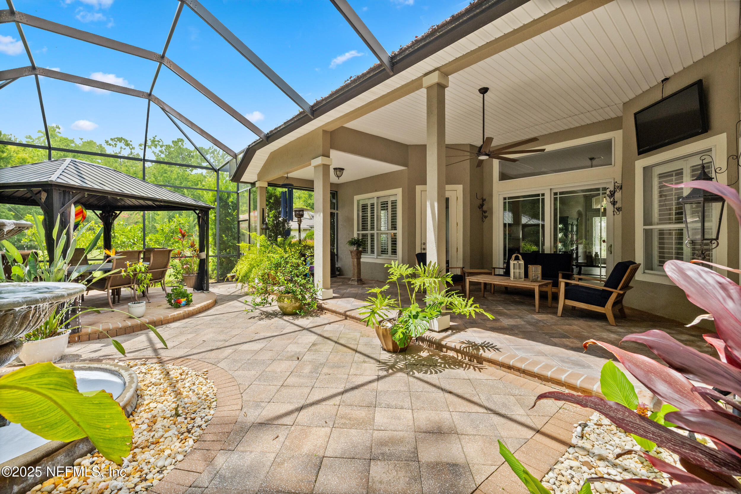 1854 West Cobblestone Lane St. Augustine, FL 32092 - Photo 12 of 72 a view of a patio with table and chairs potted plants and floor to ceiling window