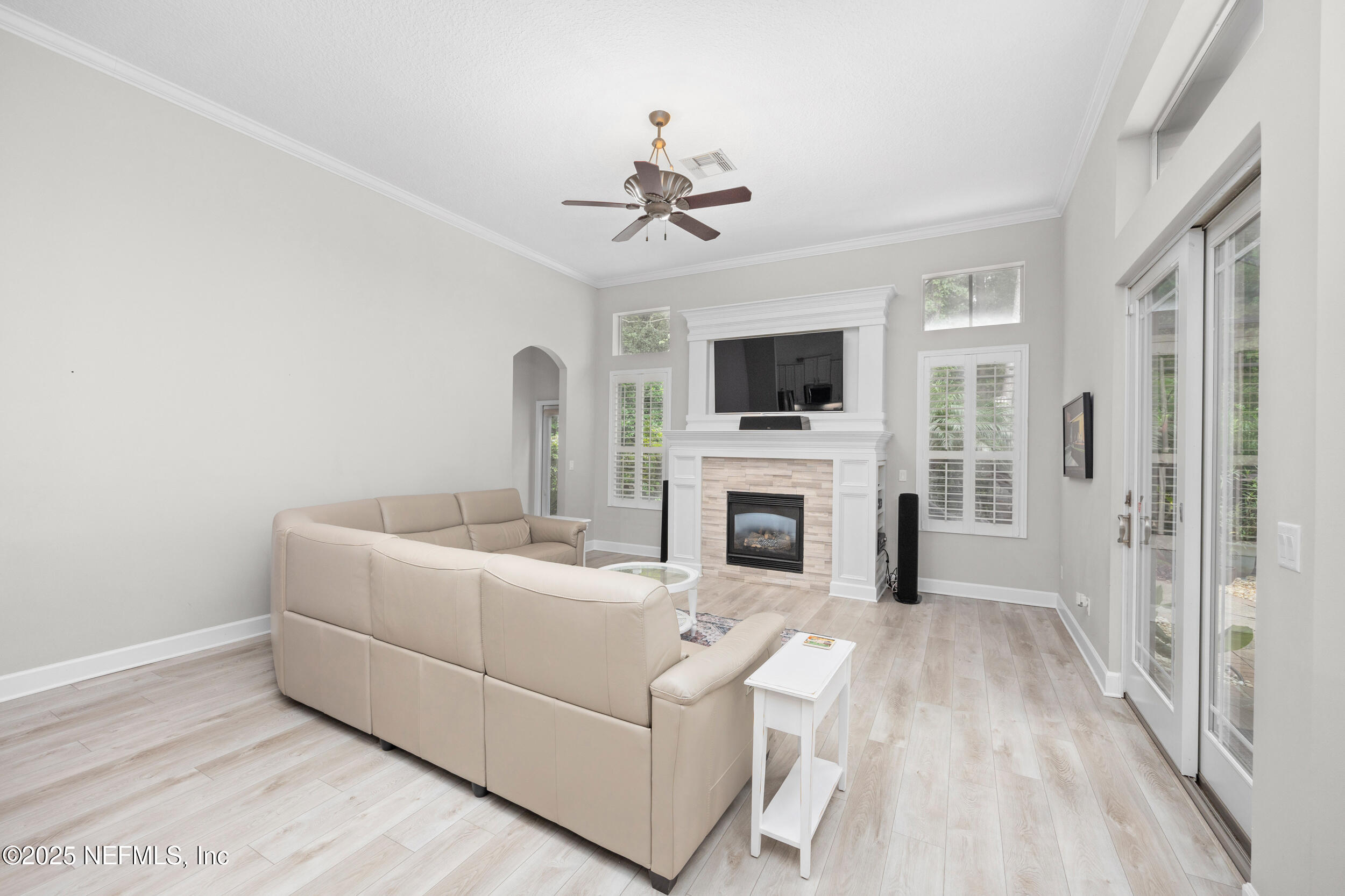 1854 West Cobblestone Lane St. Augustine, FL 32092 - Photo 25 of 72 a living room with furniture a fireplace and a flat screen tv