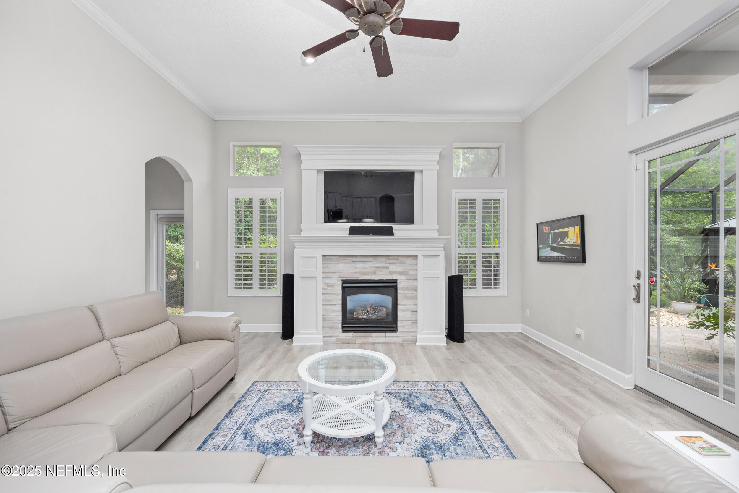 1854 West Cobblestone Lane St. Augustine, FL 32092 - Photo 26 of 72 a living room with furniture a fireplace and a flat screen tv