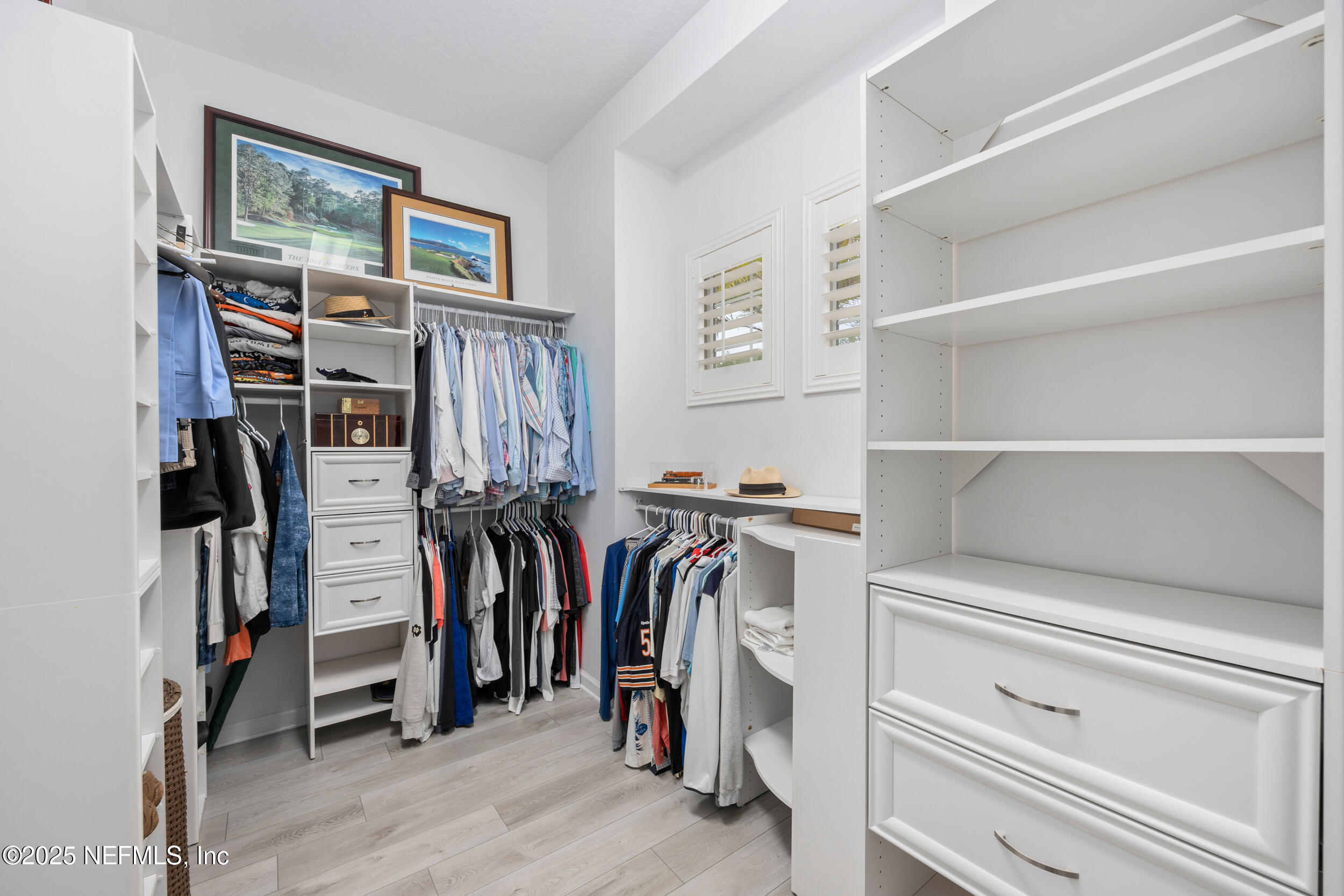 1854 West Cobblestone Lane St. Augustine, FL 32092 - Photo 44 of 72 a view of walk in closet with clothes and shoes
