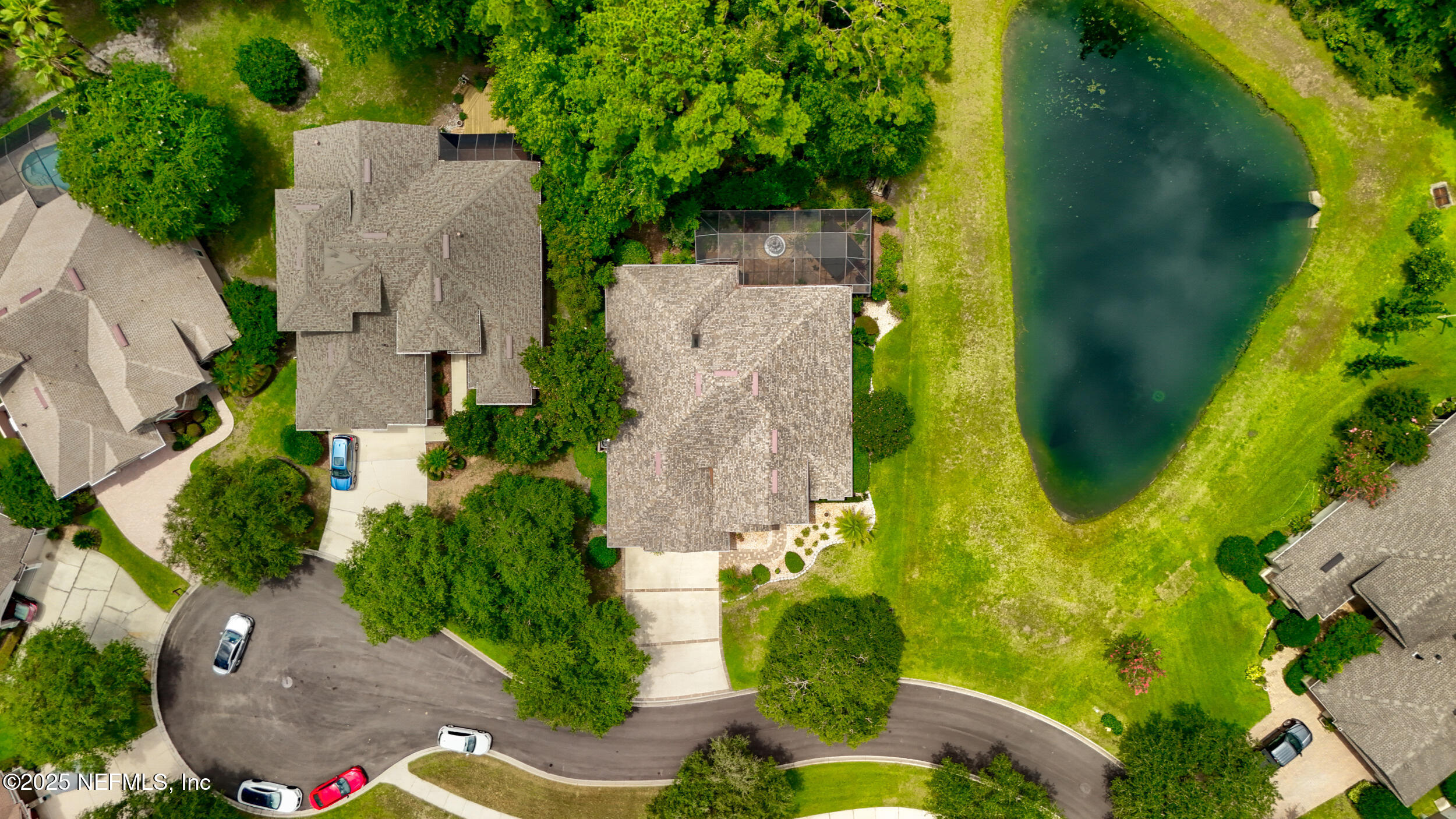 1854 West Cobblestone Lane St. Augustine, FL 32092 - Photo 46 of 72 an aerial view of a house with swimming pool and large trees