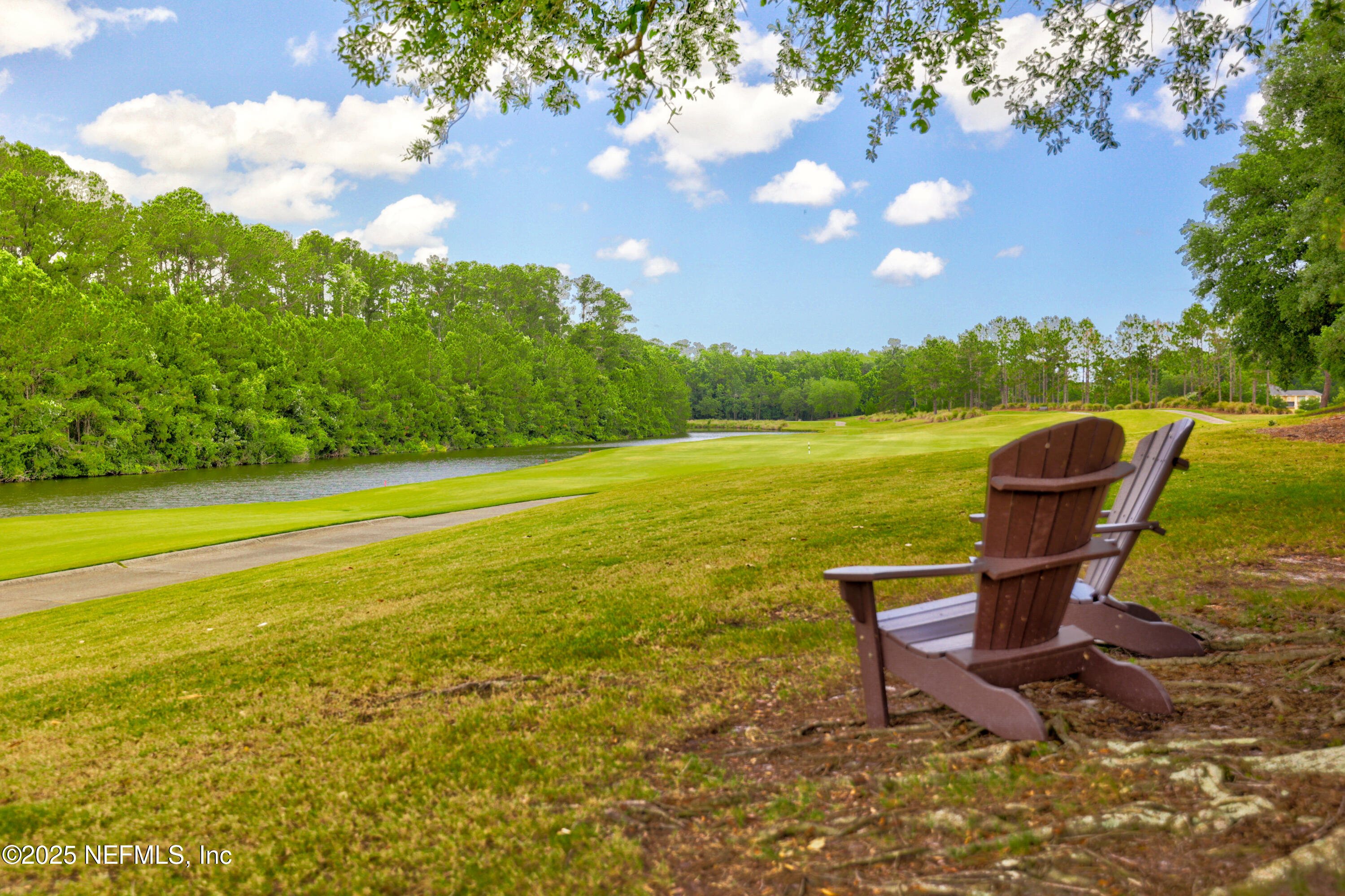 1854 West Cobblestone Lane St. Augustine, FL 32092 - Photo 54 of 72 a view of a lake with a table and chairs in the patio