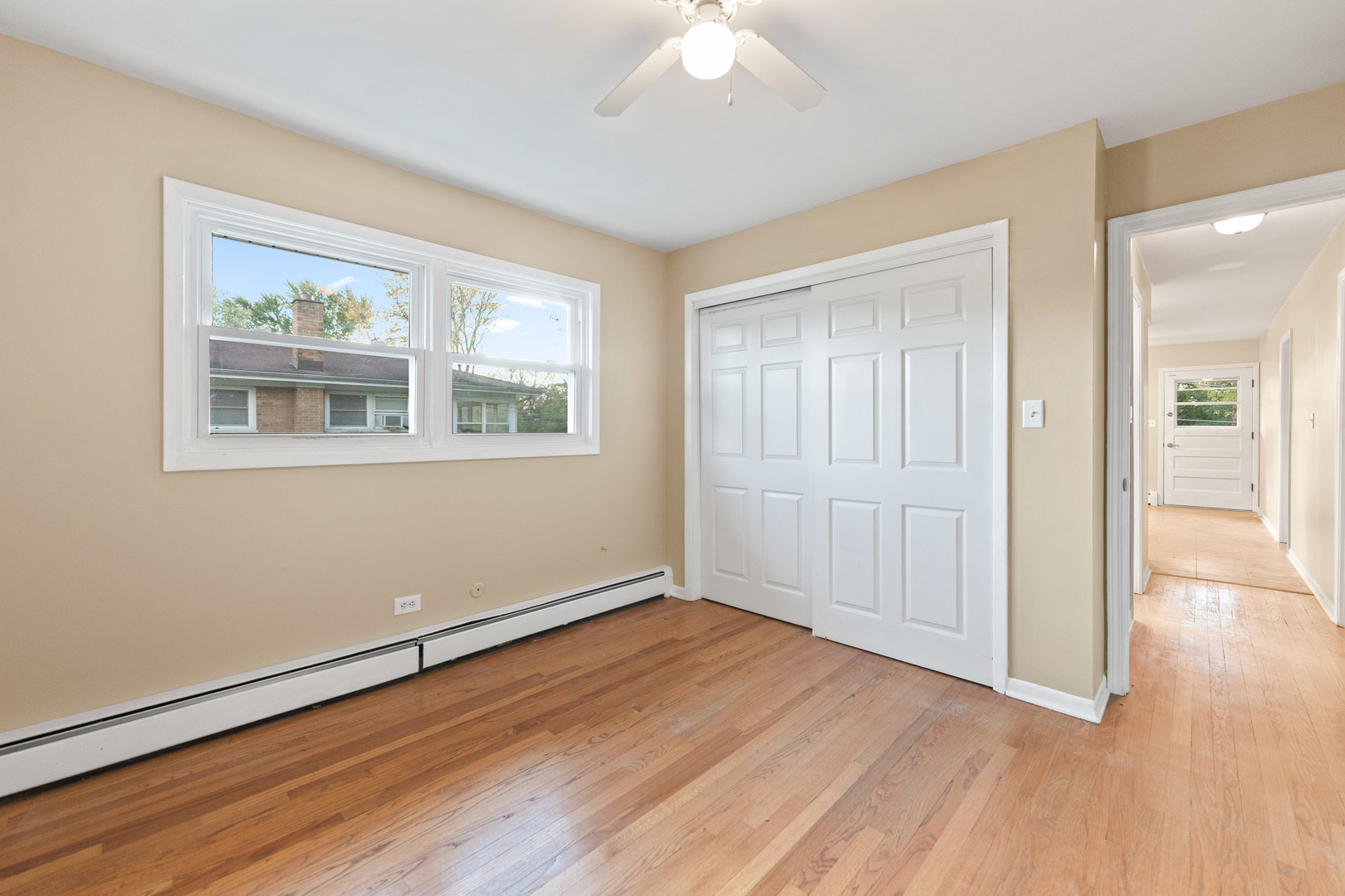 286 Wayne Court, Unit 2 Bartlett, IL 60103 - Photo 12 of 26 a view of an empty room with wooden floor and a window