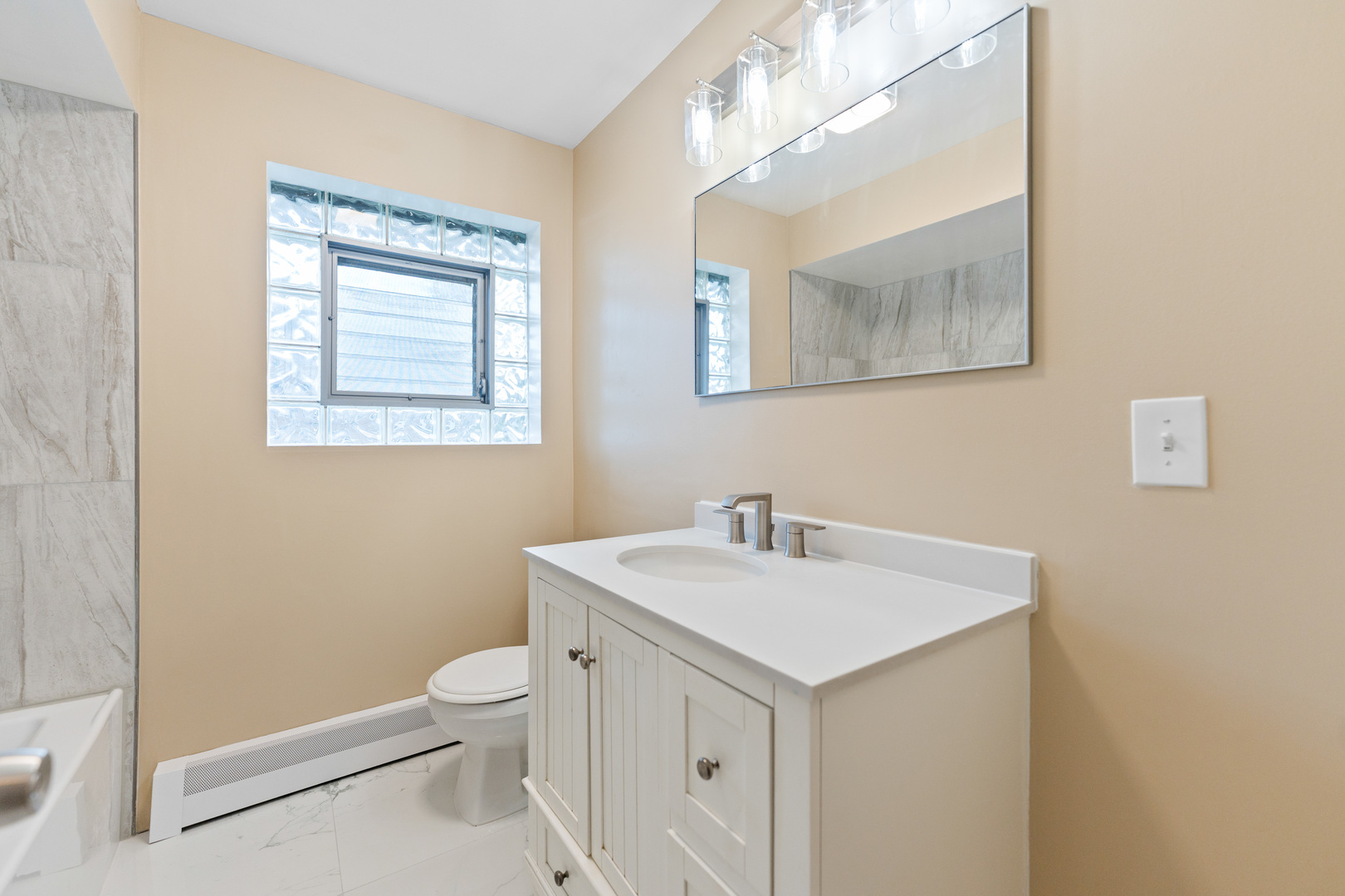286 Wayne Court, Unit 2 Bartlett, IL 60103 - Photo 14 of 26 a view of bathroom with a sink toilet and a mirror