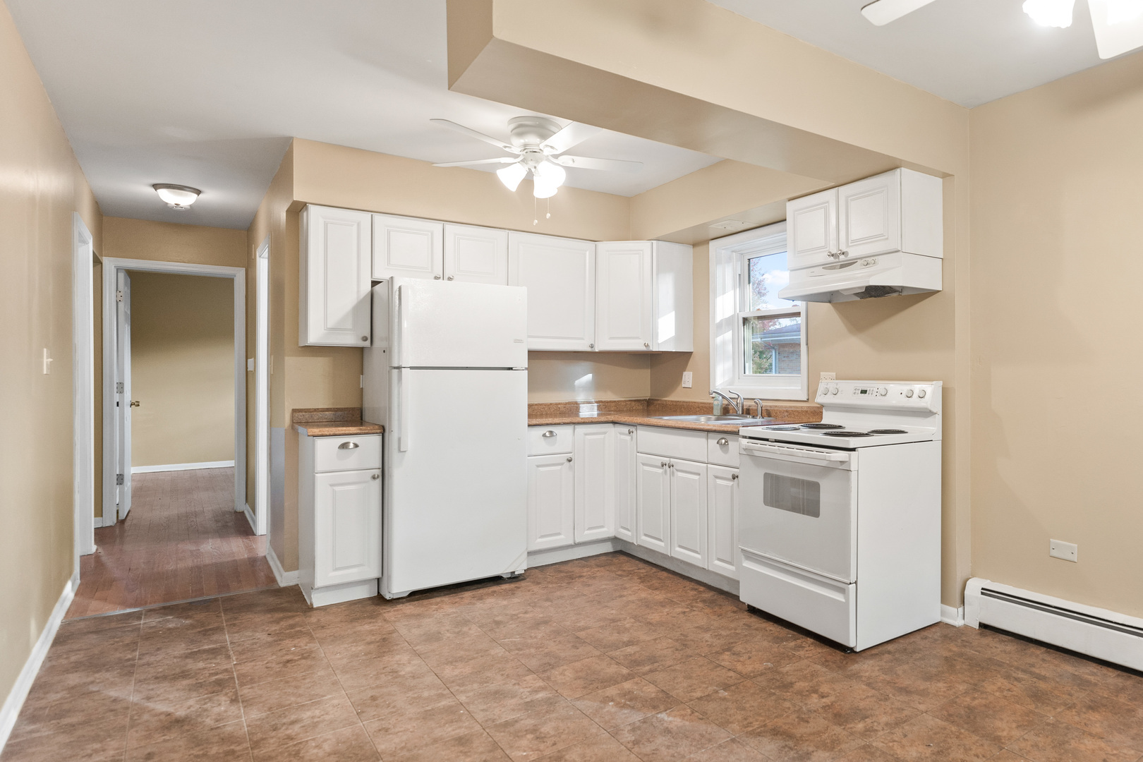 286 Wayne Court, Unit 2 Bartlett, IL 60103 - Photo 19 of 26 a kitchen with a refrigerator sink and cabinets