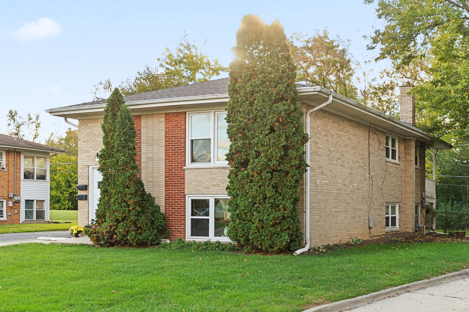 286 Wayne Court, Unit 2 Bartlett, IL 60103 - Photo 2 of 26 a front view of a house with a garden