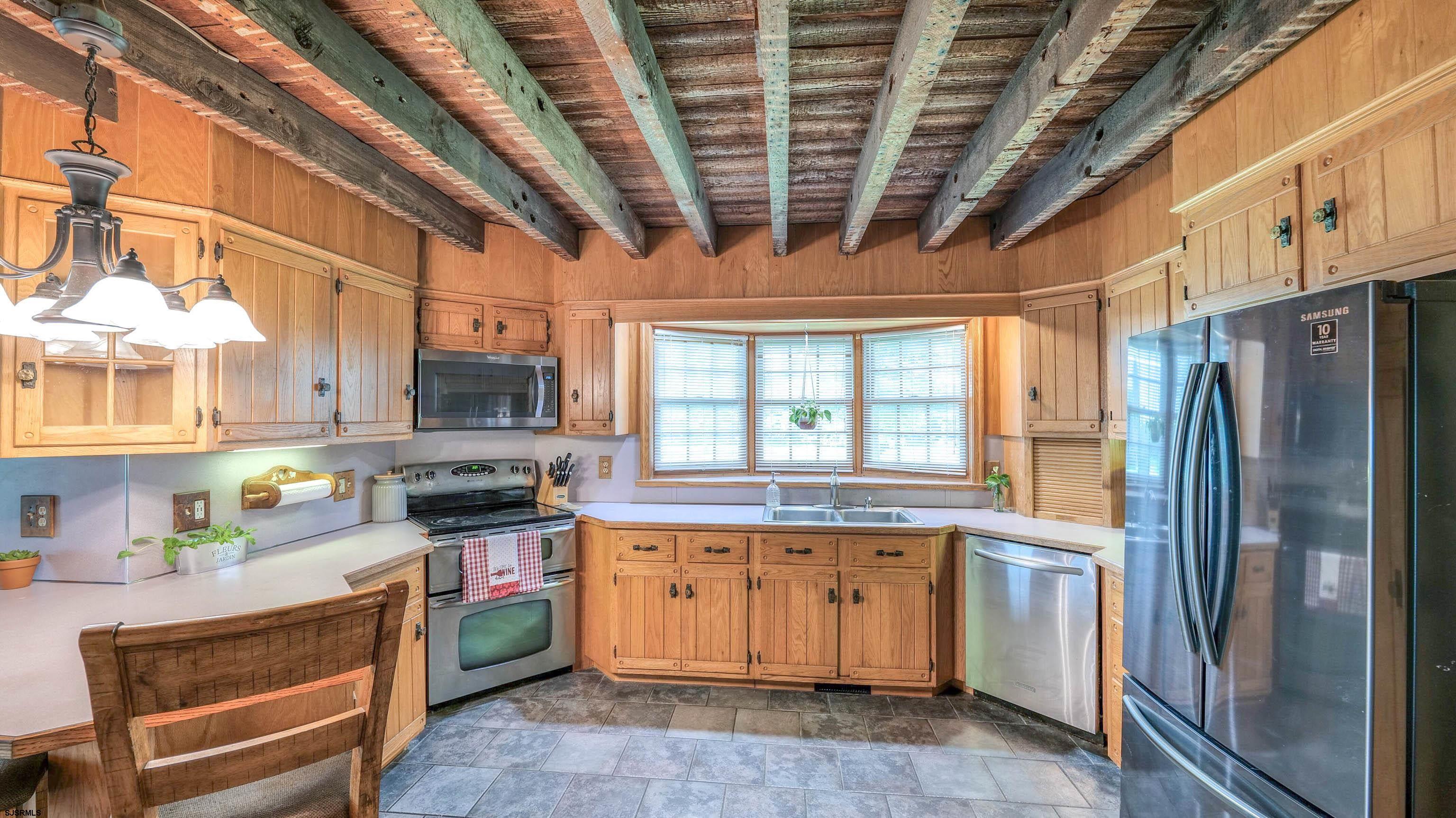 36 Cream Ridge Road Salem, NJ 08079 - Photo 23 of 53 a kitchen with stainless steel appliances granite countertop a stove a sink dishwasher a refrigerator and cabinets with wooden floor