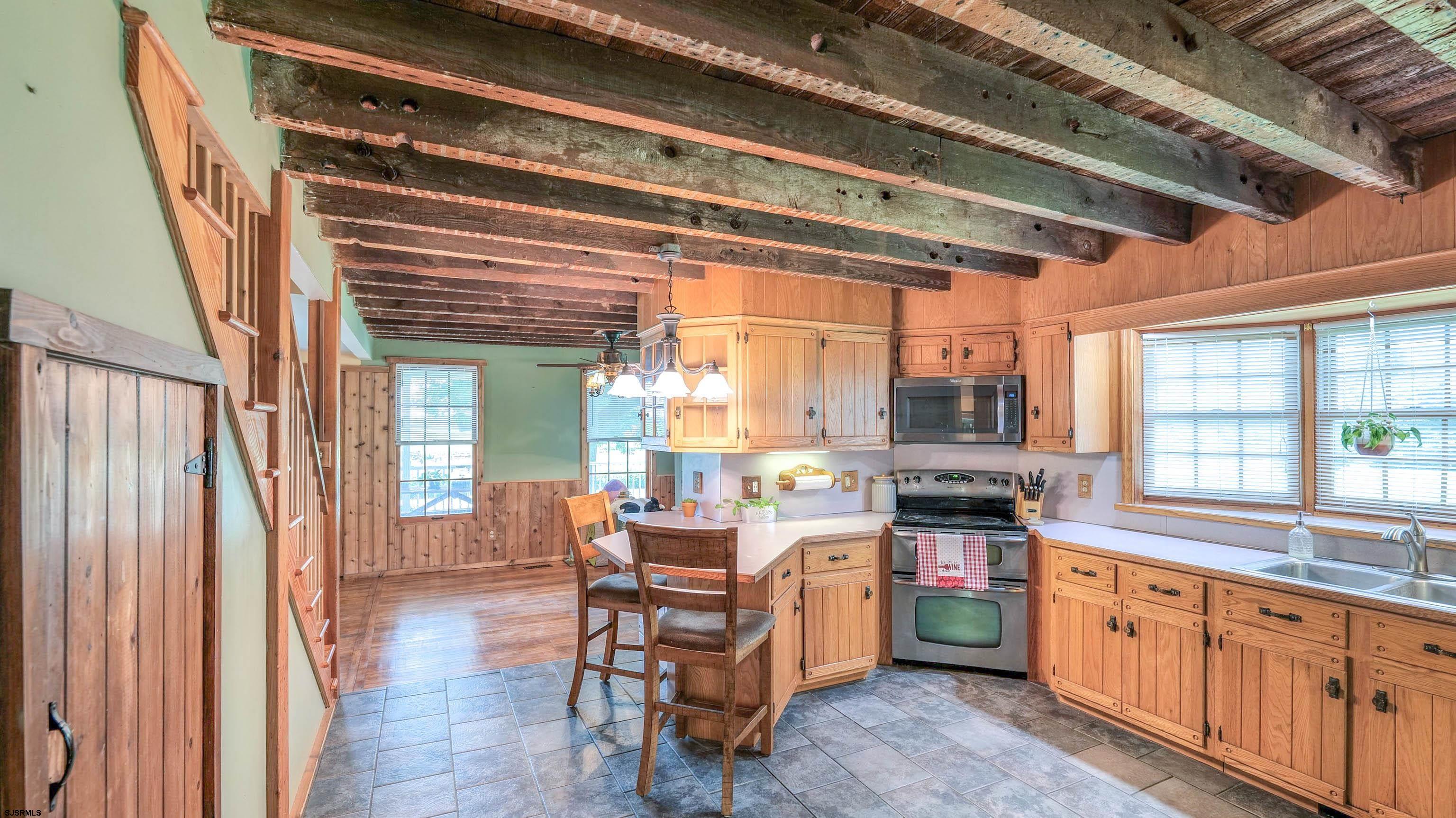 36 Cream Ridge Road Salem, NJ 08079 - Photo 25 of 53 a open kitchen with stainless steel appliances granite countertop a stove top oven a sink and cabinets with wooden floor