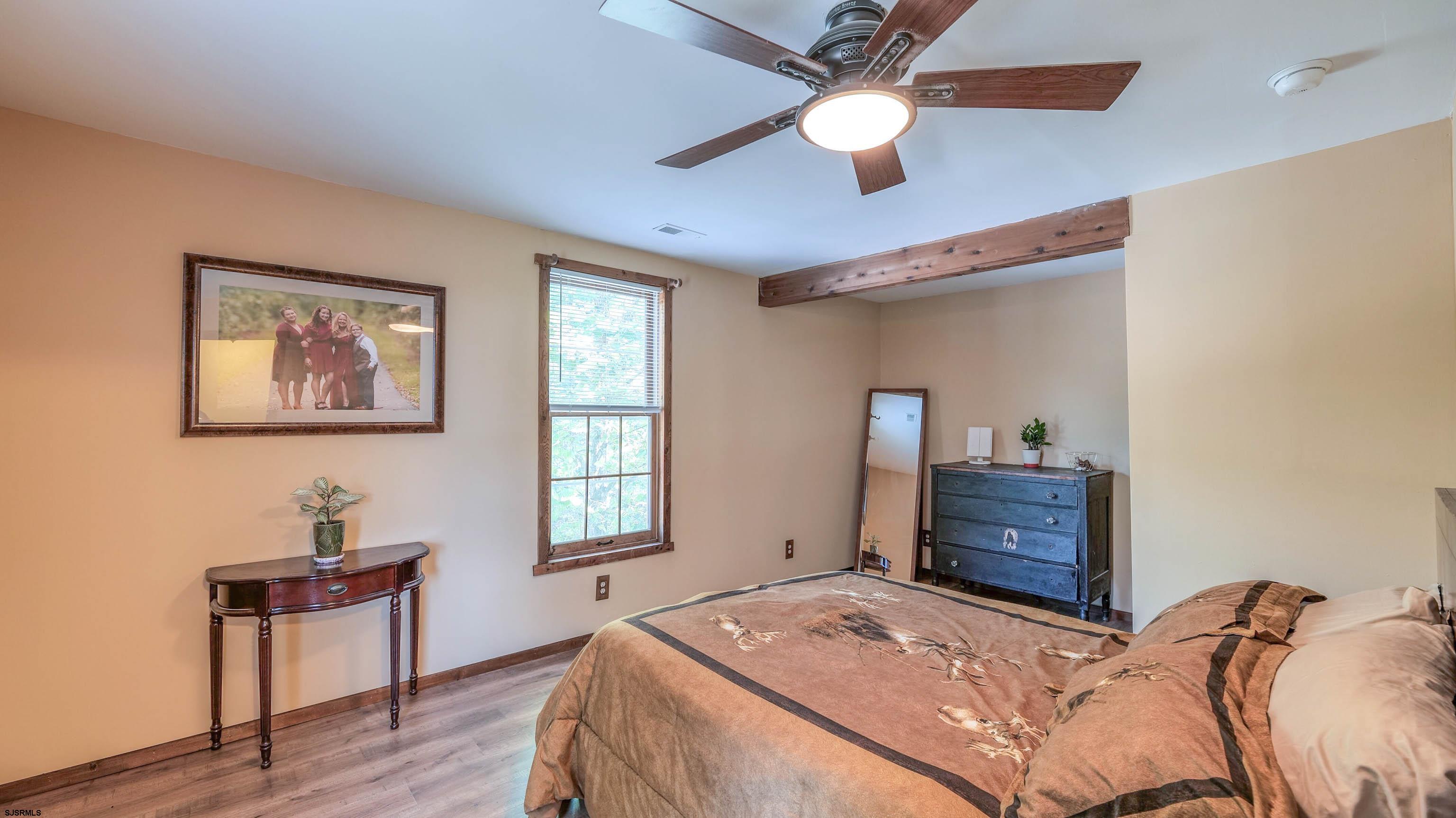 36 Cream Ridge Road Salem, NJ 08079 - Photo 35 of 53 a bedroom with a bed and a chandelier