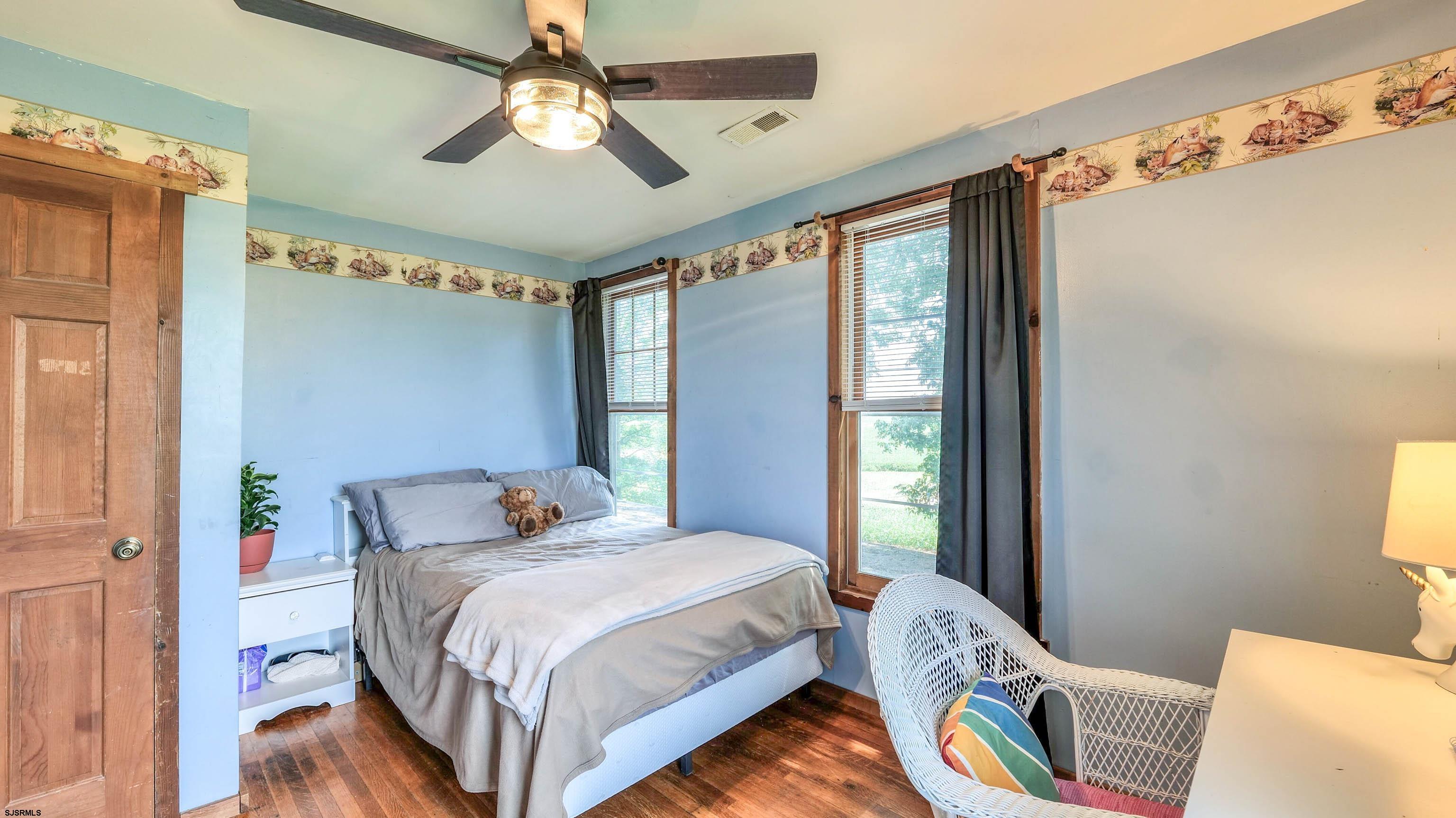 36 Cream Ridge Road Salem, NJ 08079 - Photo 40 of 53 a bedroom with a bed and a chandelier